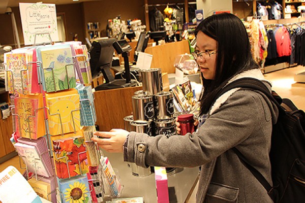 Lin Fan Li looks over a display of greeting cards