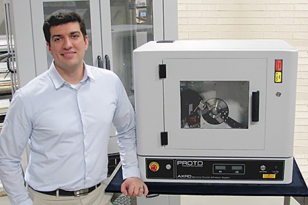 Nick Vukotic poses with Proto Manufacturing’s benchtop powder X-ray diffraction system.