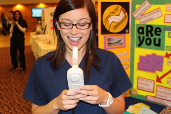 A nursing student prepares to test the carbon monoxide content of her lungs during a 2012 wellness fair. 