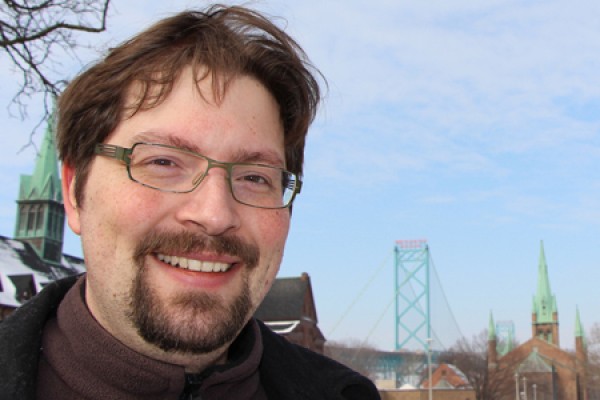 Paul-Matthias Tyrell poses in front of Ambassador Bridge