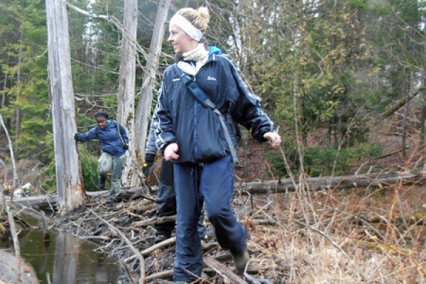 Geoscience students Marija Lelas and Leima Moro cross a beaver dam during their third-year course in field mapping. 