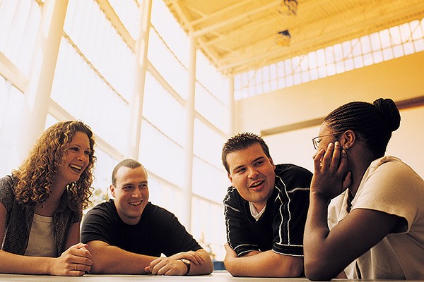 students gathered around table