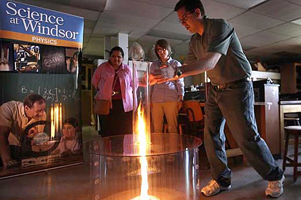 Steven Rehse (right) shows off the fire tornado to Chitra Rangan and Florida Doci.