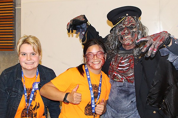 Katrina Hermle and Catherine Muldoon pose with undead fire chief Bruce Montone