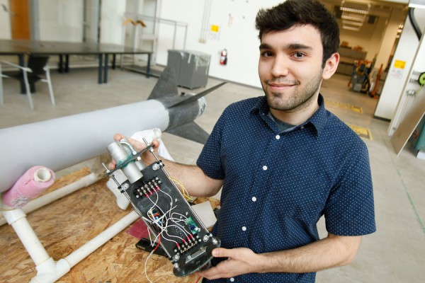 Atilla Saadat holds an avionics bay