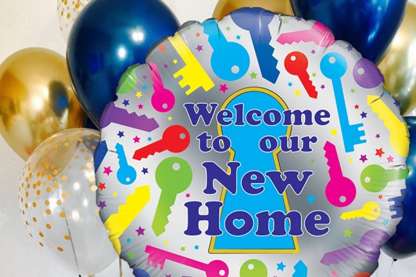 balloon reading &quot;Welcome to our new home&quot;