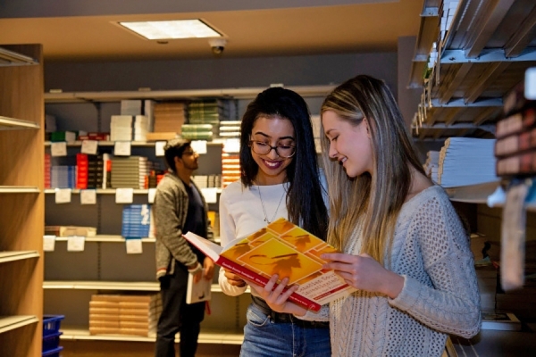 students looking at textbook