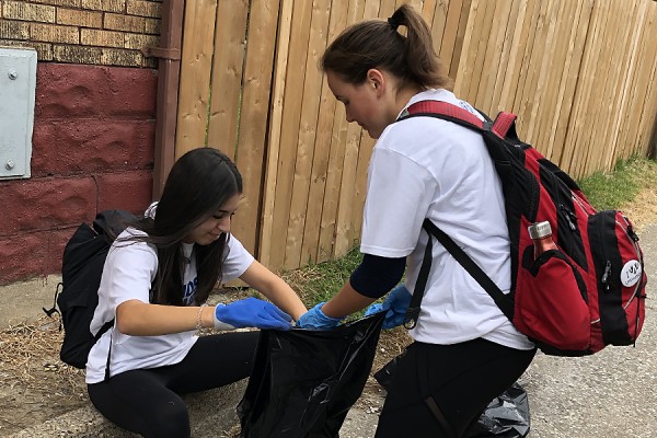 Volunteers pick up litter during #OurCommunity Clean-up Day, Sept. 9.