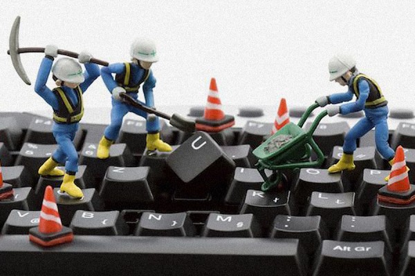 toy workers digging up keyboard