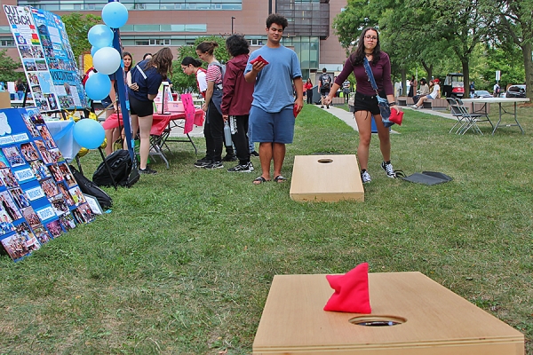 Students play a beanbag toss game during orientation.