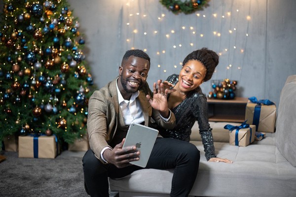 couple sitting near Yule tree