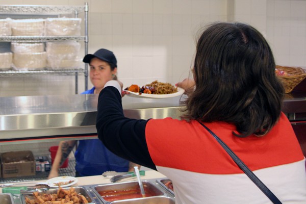 woman receiving dish of food