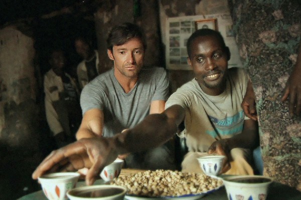 Hugh Jackman learns about the value of fair trade coffee on the Ethiopian farm of host Dukale.