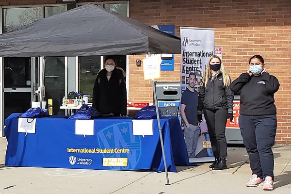 Volunteers from the International Student Centre hand out welcome kits Thursday outside Vanier Hall.