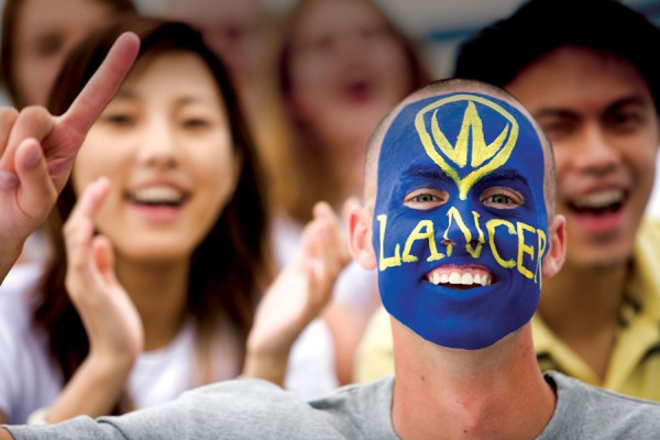 Lancer fan with face painted blue and gold
