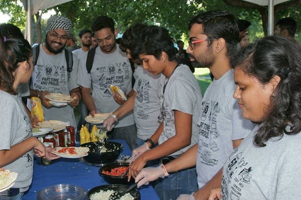 Wearing “Part-time and Proud” T-shirts, volunteers serve diners at the 17th annual barbecue of the Organization of Part-time University Students.