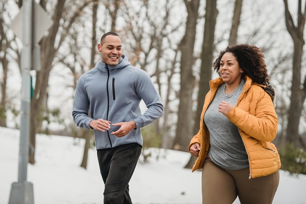 couple running in snowy outdoors