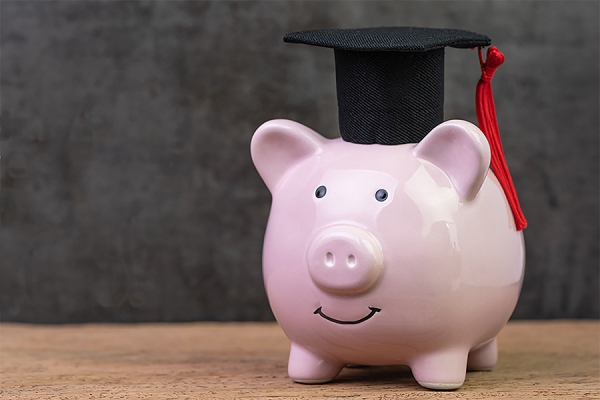 piggy bank wearing a mortarboard