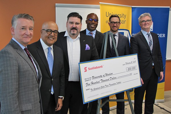 Douglas Kneale, Alex Besharat, Terry Roman, Charles Achampong, Sean White, Bill Anderson posing with large comically cheque