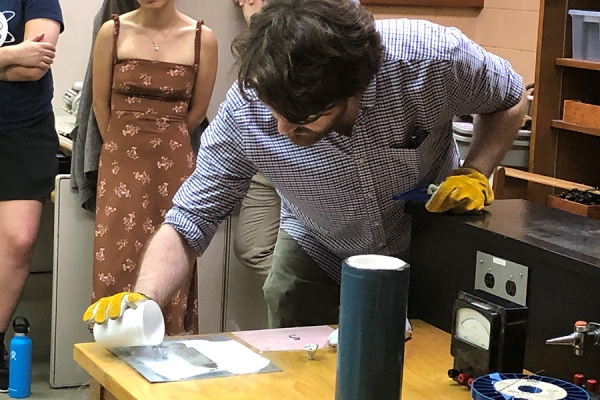 Prof. Jeff Rau conducts a demonstration for high school science students during Physics Academy. 