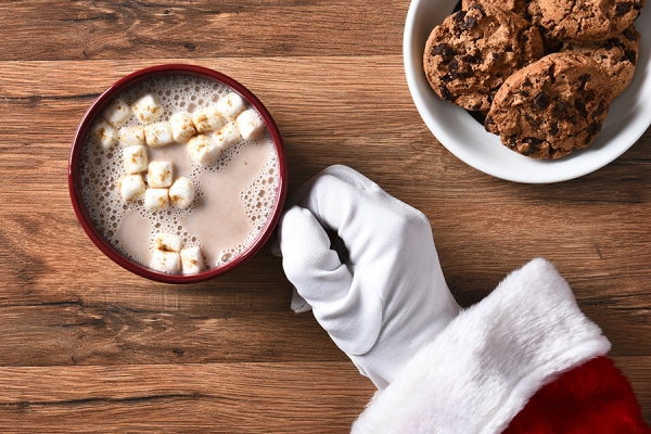 Santa&#039;s hand holding mug of cocoa