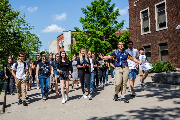 student ambassador leading tour of campus