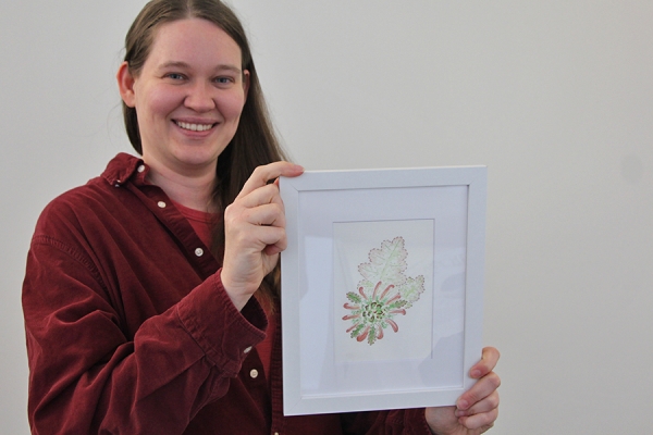 Sarah Smitherman holding a watercolour painting