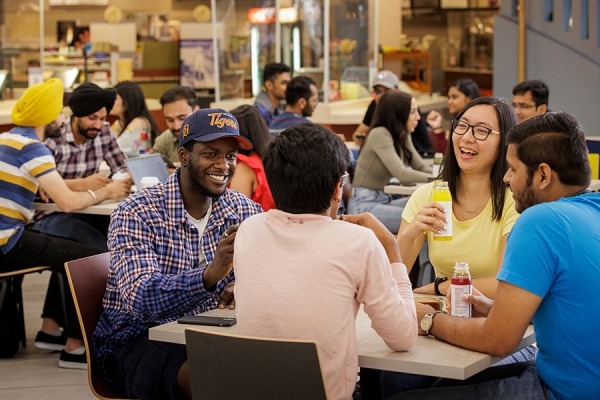 students conversing in student centre