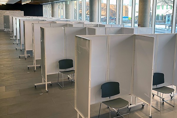 Interior of Windsor Hall showing individual cubicles for administering vaccines in its lobby.