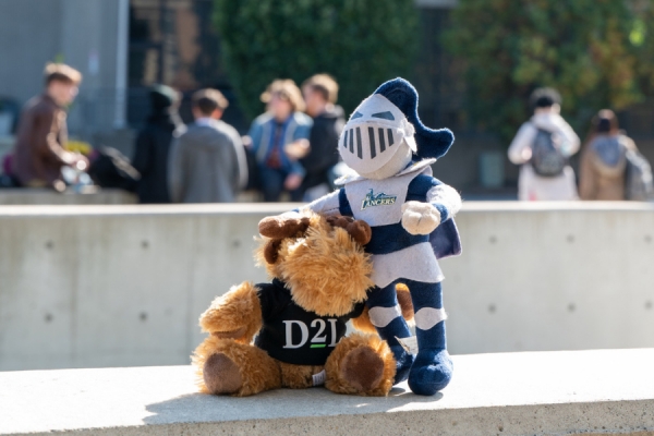 D2L mascot Morris the moose with Lancer mascot Winston