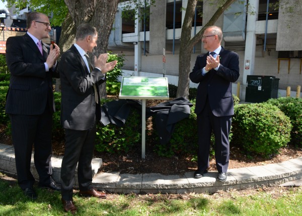 Mark Chauvin of TD Bank Group (r.), Windsor Mayor Drew Dilkens (l.), UWindsor President and Vice-Chancellor Alan Wildeman (left-center) unveiled a new sign, marking the green space on Chatham St. as the TD Chatham Street Parkette, June 2. 