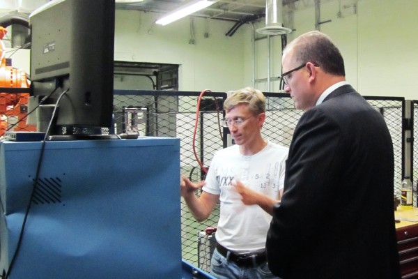 Windsor mayor Drew Dilkens (r.) listened to Dr. Andriy Chertov (l.) presentation on the “In-Line Spot Weld Quality Analysis” project, during his recent visit to UWindsor’s  Institute for Diagnostic Imaging Research.