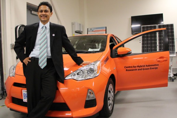 Narayan Kar with orange Prius