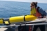 two women prepare to launch underwater drone from boat