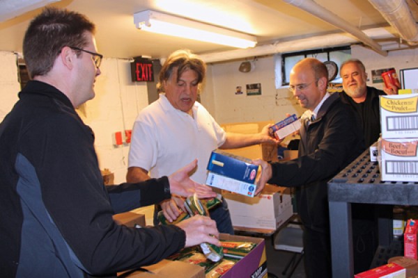 Rob Aitkens, Chris Kolonelos, John Powell and Dean Roy stocking shelves 