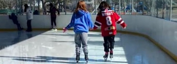 kids skating on rink in park