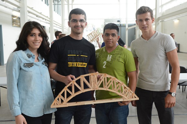 Mariam Hamadani, Khaled Alhakim, Felipe Paramo and Darius Ghib holding bridge