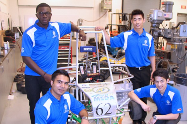 Students pose with the electric vehicle they helped to design and build.