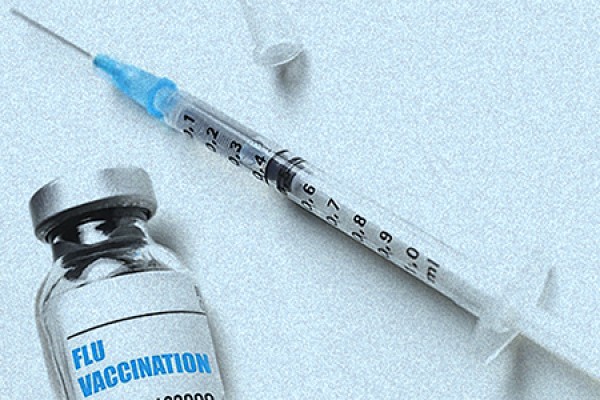 syringe and needle with vial containing flu vaccine