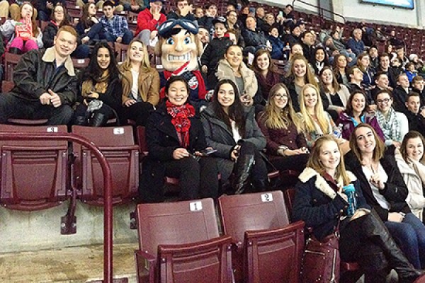Sport management students surround Windsor Spitfires mascot Bomber during a game at the WFCU Centre.