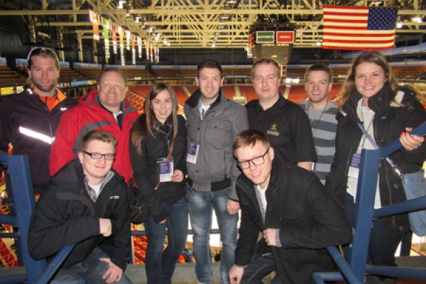 Students pose with professor Scott Martyn in the Lake Placid arena that hosted the 1980 “Miracle on Ice.”