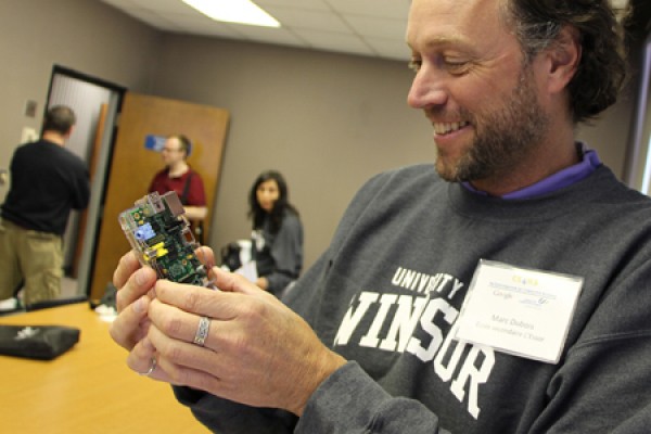 Marc Dubois, a teacher at Ecole secondaire L’Essor, looks over a Raspberry Pi.