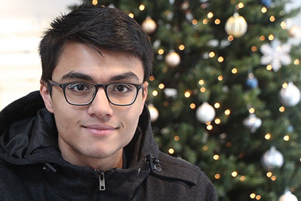 student sitting in front of tree