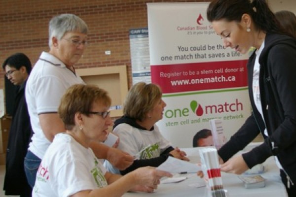 people lined up at One Match registration table