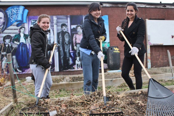 Volunteers work in a community garden on Ford City’s Drouillard Road.