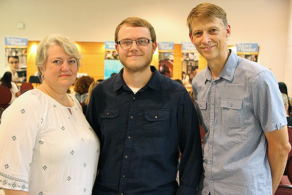 Mother Mary-Lyn and father James flank first-year computer science student Adam Vandolder.