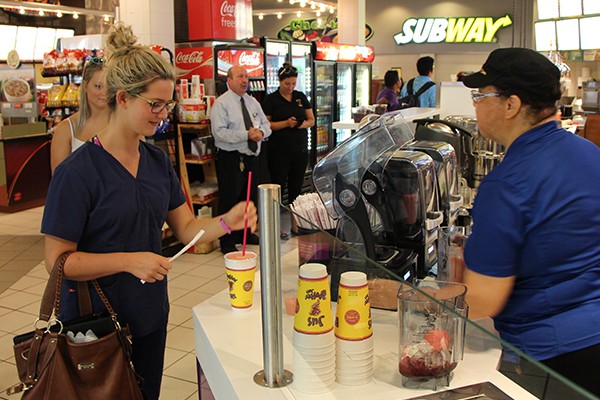 Mia Zecca accepts her Booster Juice from server Colleen Lee-Gray