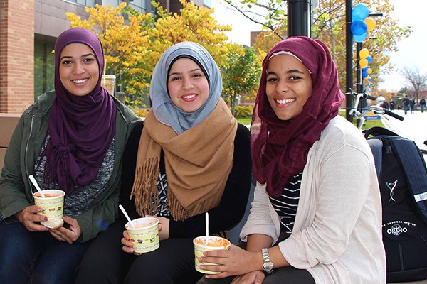 Afnane Kraba, Sarah Al-Zaher and Khadija Shamisa enjoy bowls of chili