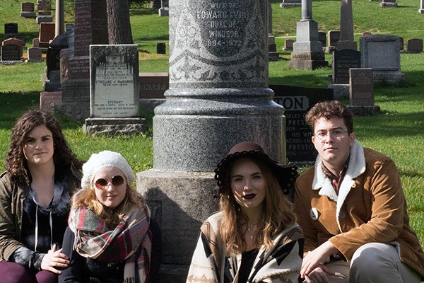 Members of the cast of Queen Milli of Galt pose below the grave marker of Millicent Milroy
