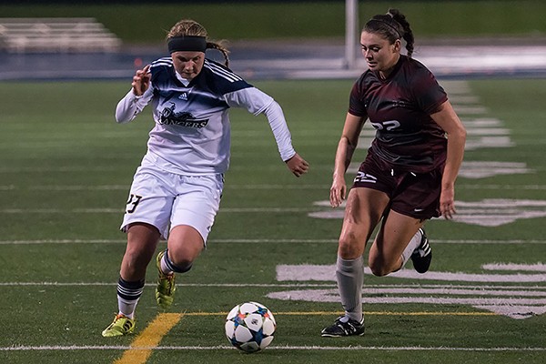 Rookie midfielder Chelsea Zavitz competes for the ball against Mac’s Mary Craig. 